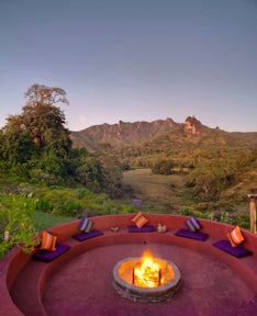 Fireplace outside Bale Mountain Lodge with mountains in background