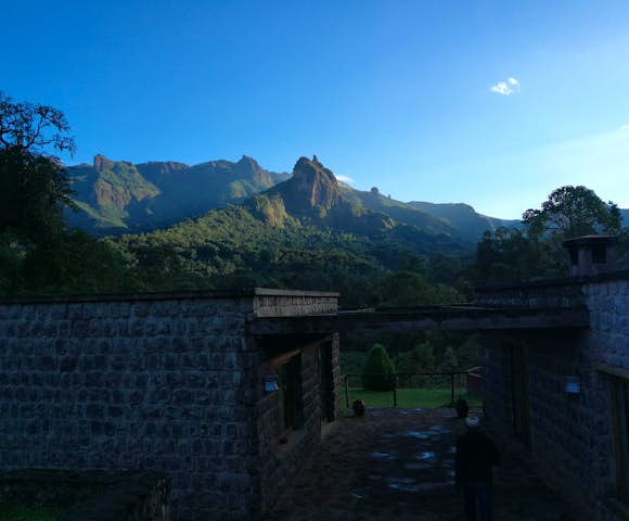 Bale Mountains Lodge entrance and mountain under blue sky
