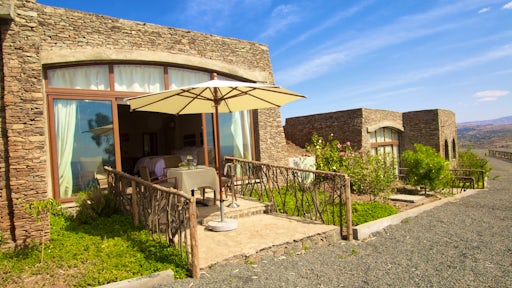 Bedroom and dining table on veranda at Gondar Hills Resort