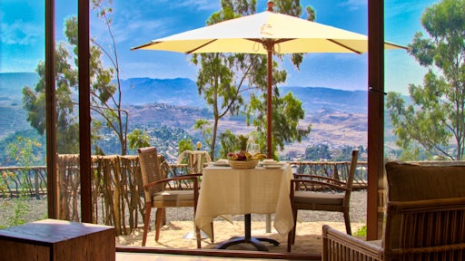 Dining table with mountains in the background at Gondar Hills Resort
