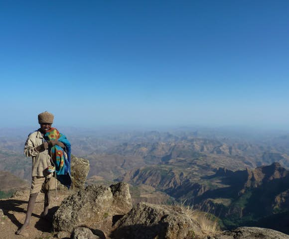 Boy in front of Simien Mountains landscape 